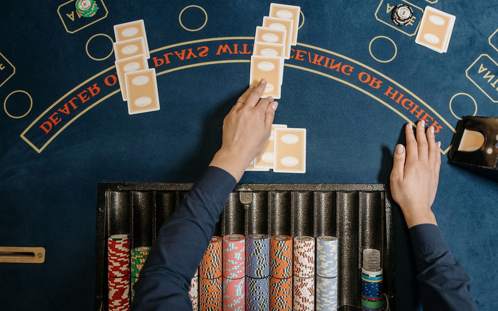 Warm light pools across a dressed table with symbolic tokens and cards