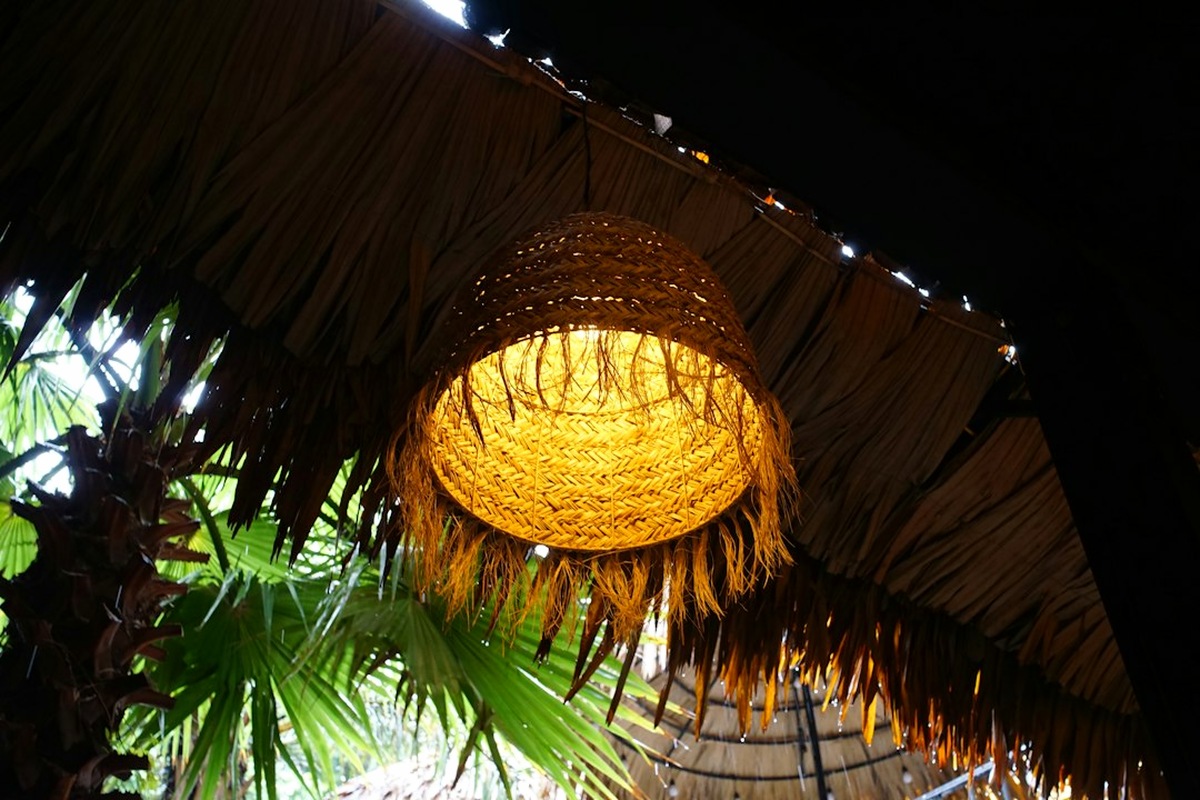 Themed destination station with palm leaves, lanterns and woven textures