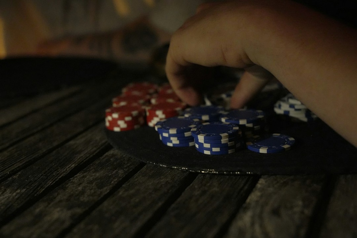 Poker table with identical token stacks laid out at each seat before play