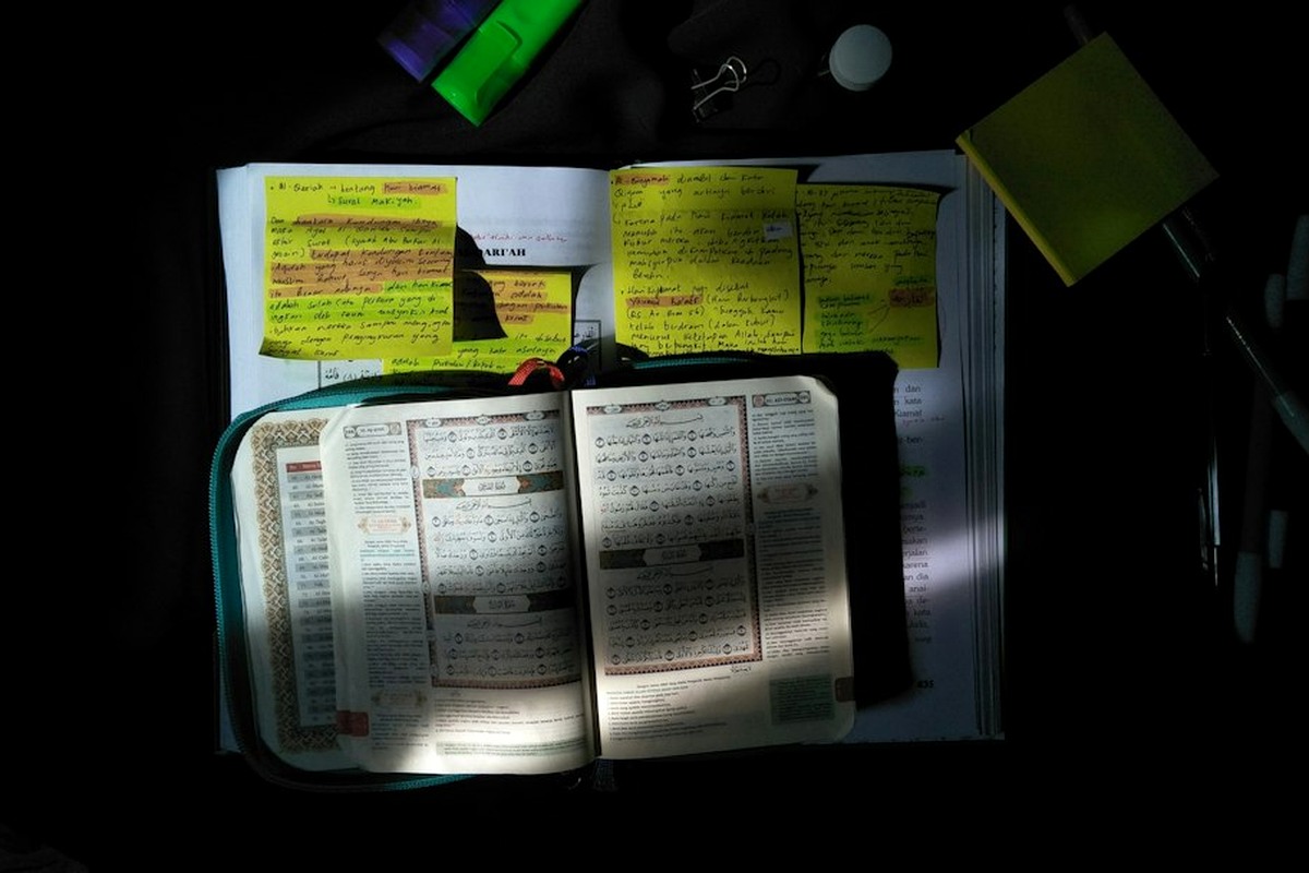 Open briefcase with themed props and a dossier folder on a dark table