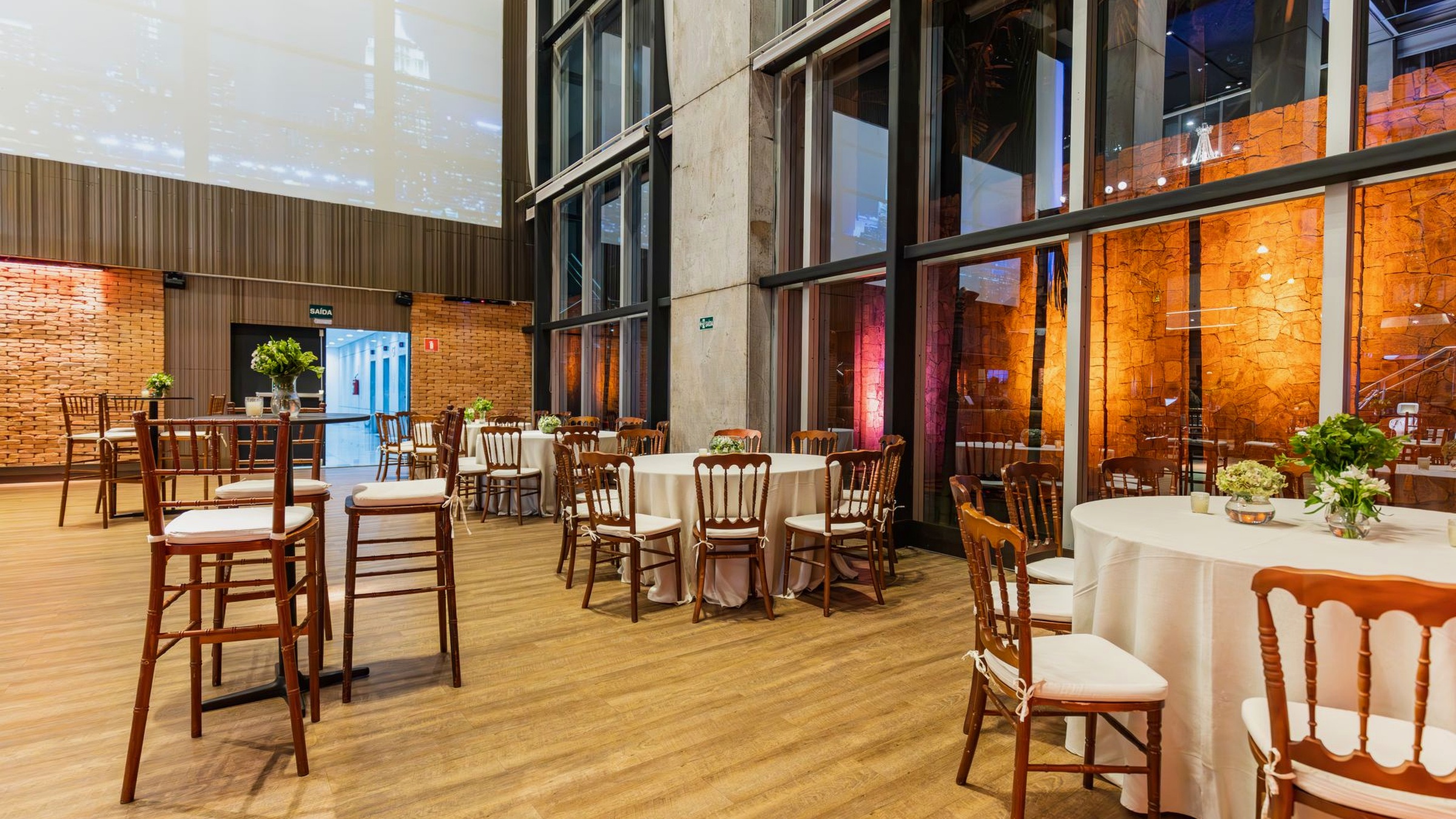 Function room dressed for a casino-style evening with lit tables and a photo corner