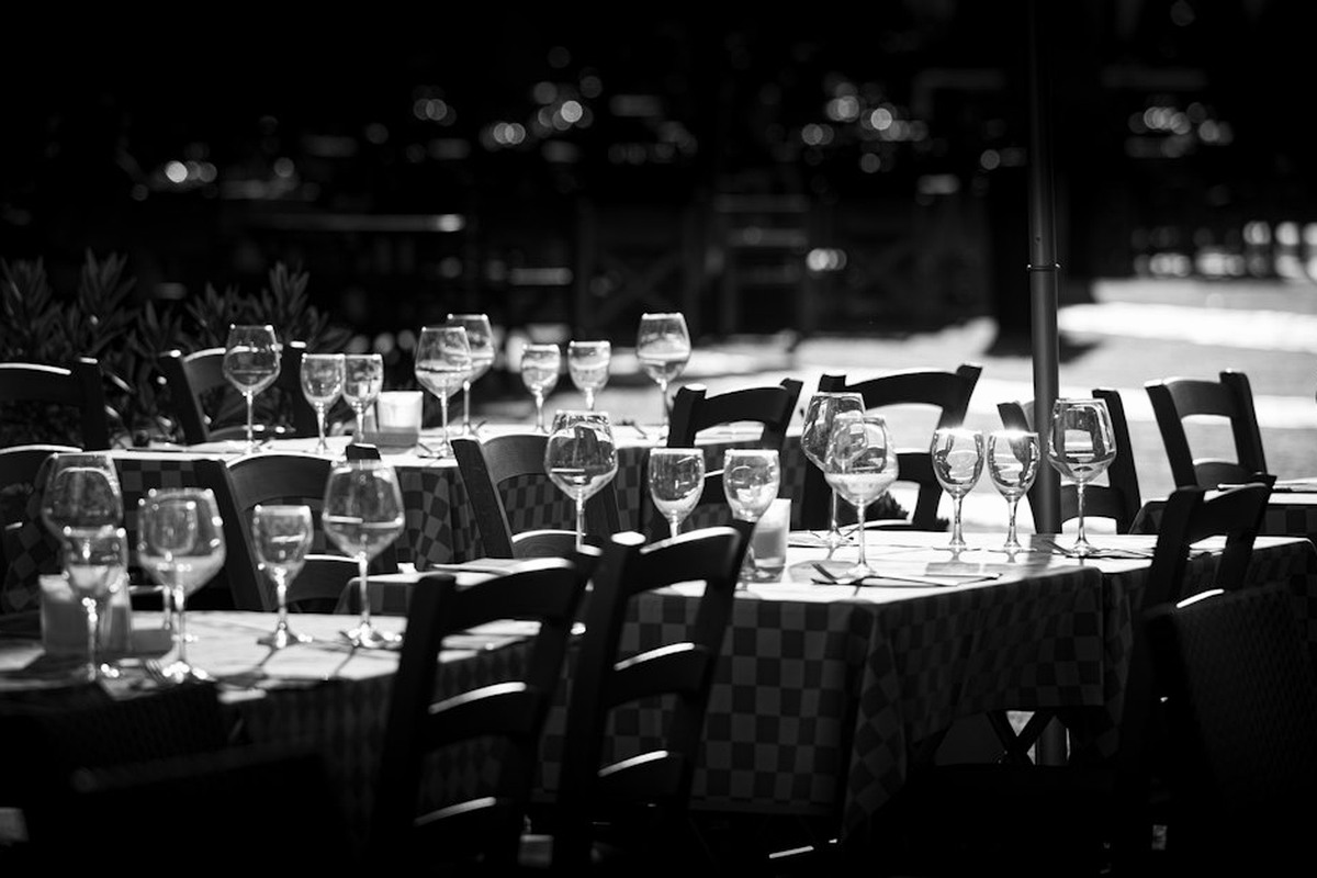 Dressed dinner tables with a lit stage end of the room before guests arrive